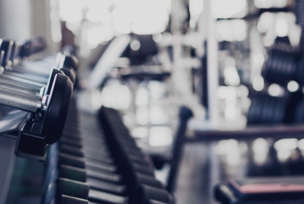 Blog - gym interior background of dumbbells on rack in fitness and workout