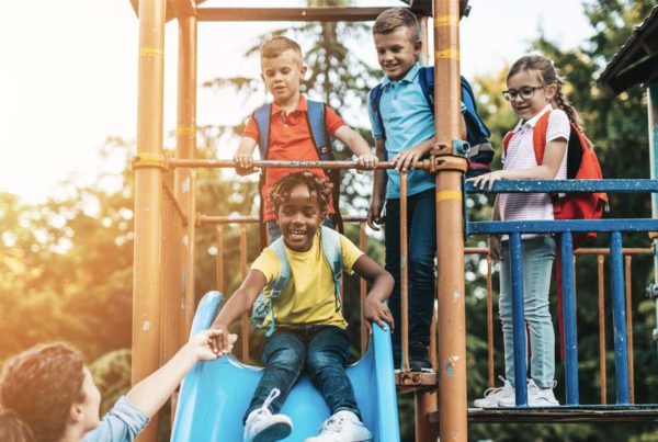 Keep Your Child Safe on Outdoor Play Equipment - Group of Children Playing at a Playground at Sunset