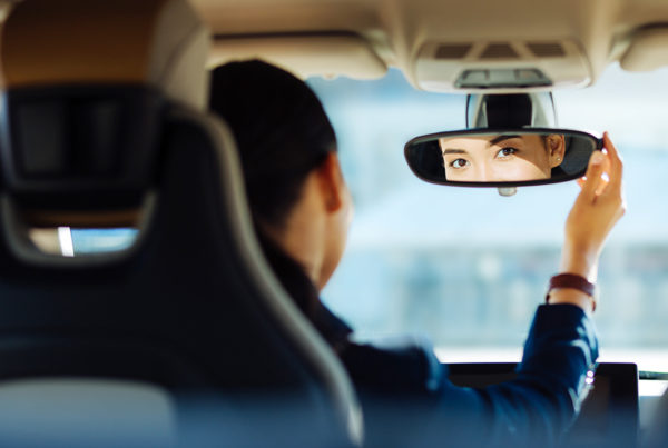 Technology Helps Identify, Reward Safe Drivers - Woman in Car Checking Mirrors and Driving Safely