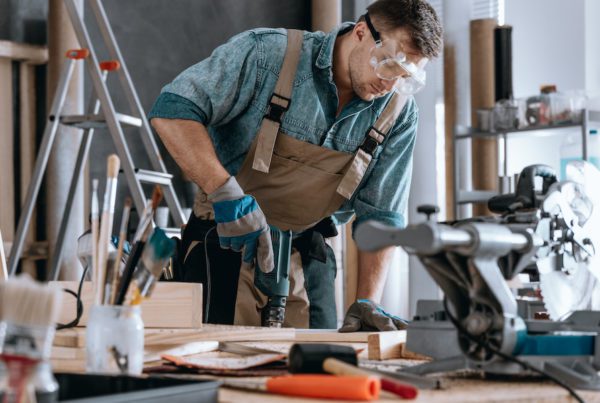 Young contractor drilling hole