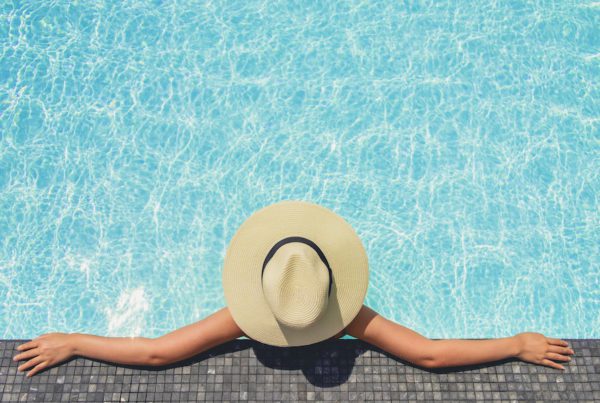 Carefree woman relaxation in swimming pool summer Holiday concept