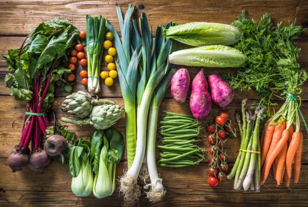 table filled with fresh vegetable produce