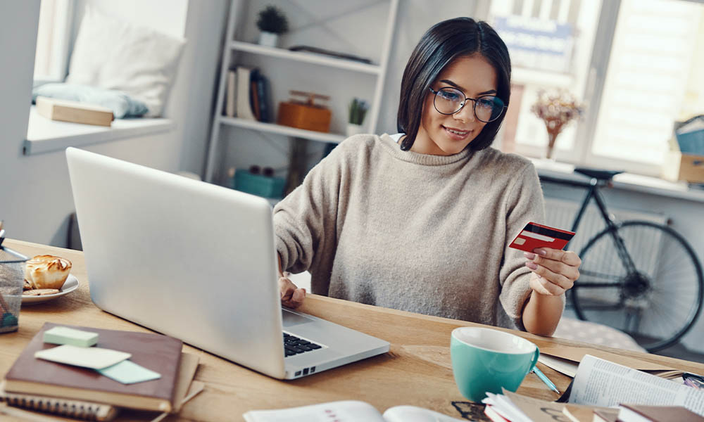 Blog - Young Woman in Shopping Online Using Laptop While Sitting Indoors